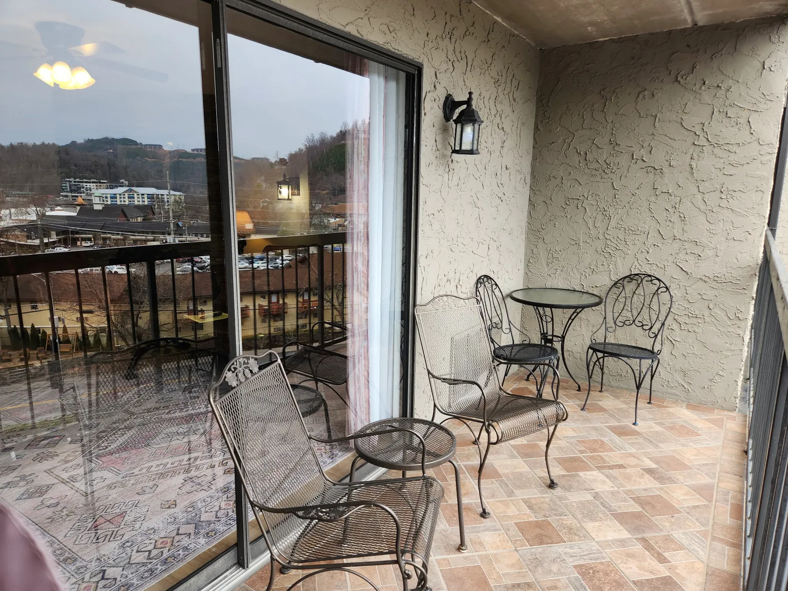 Step onto your private balcony where charming wrought-iron seating invites you to unwind with morning coffee while taking in peaceful city views.