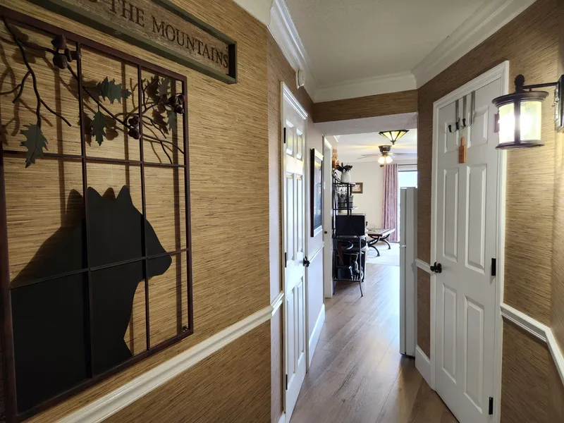 Step into your mountain retreat through this welcoming hallway, where rustic charm meets modern comfort with beautiful wood accents and thoughtful touches.