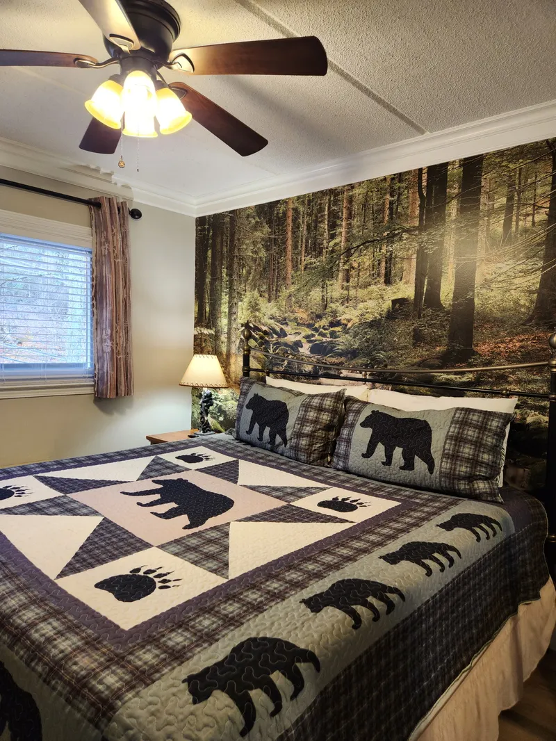 Drift into rustic dreams in your cozy bedroom, where wilderness-themed bedding meets forest murals for the perfect mountain retreat atmosphere.