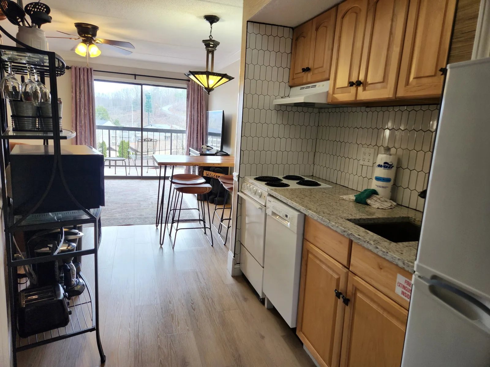 Your fully-equipped kitchen flows seamlessly into the dining area, with granite counters and all the essentials for cooking.