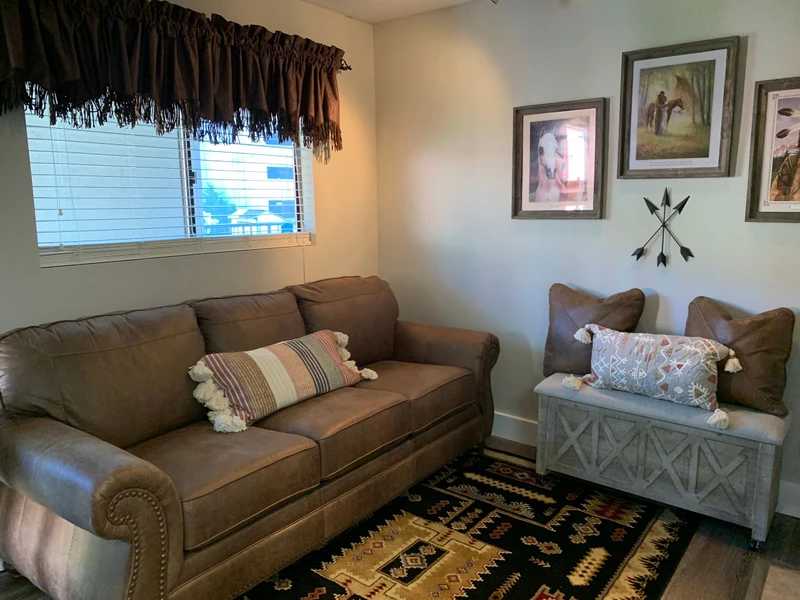 Sink into this cozy living room where rustic charm meets comfort. Your retreat features plush seating and thoughtful western-inspired touches.