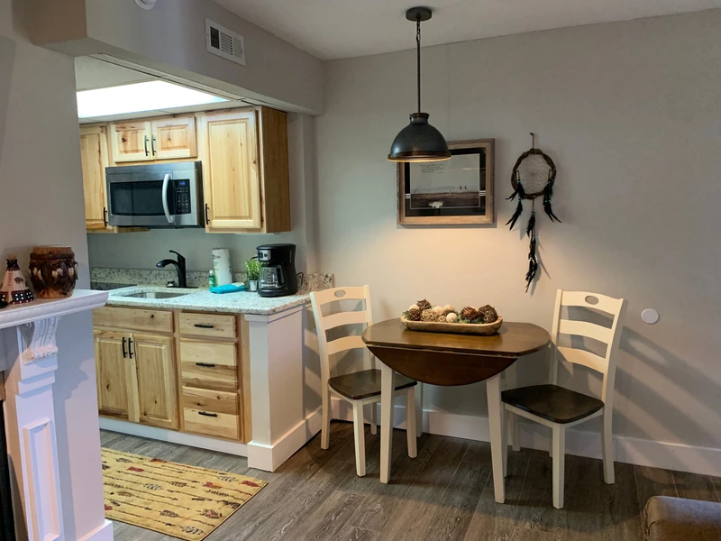 Your cozy dining nook awaits with warm wood tones and charming decor, perfect for morning coffee or intimate meals.