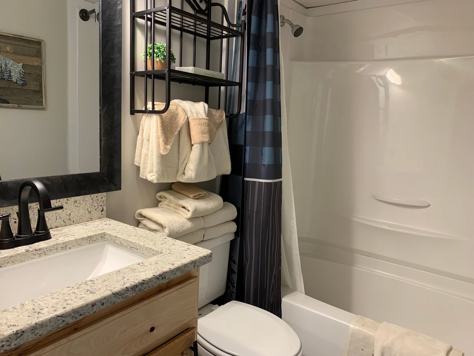 Your stylish bathroom features fluffy towels, granite counters, and a spacious tub-shower combo for ultimate relaxation.