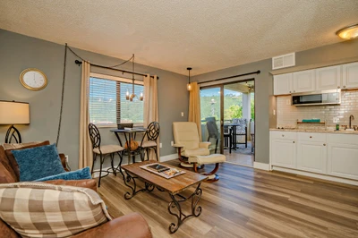 Step into your bright, open-concept retreat where natural light pours through large windows revealing mountain views. Relax in the cozy living area or enjoy meals by the balcony, with modern kitchen amenities close at hand.