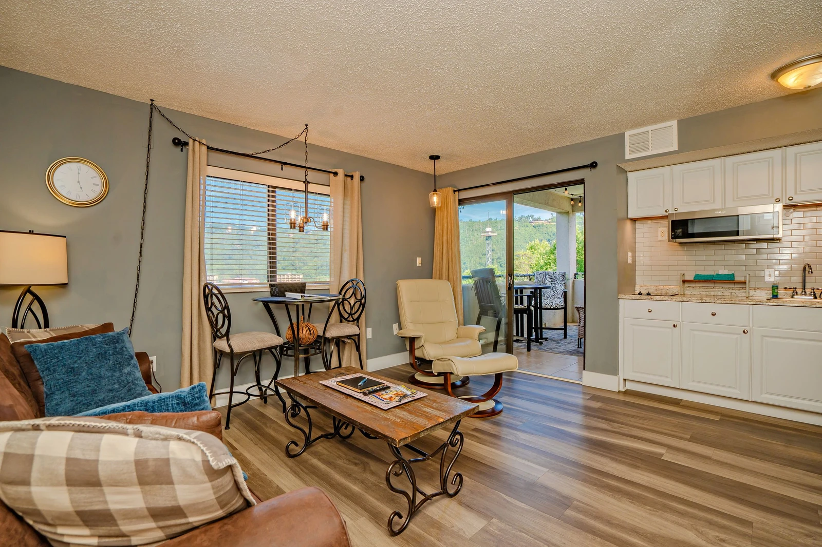 Step into your bright, open-concept retreat where natural light pours through large windows revealing mountain views. Relax in the cozy living area or enjoy meals by the balcony, with modern kitchen amenities close at hand.