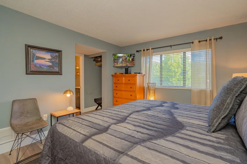 Unwind in your peaceful bedroom, where soft natural light filters through the windows and a plush bed invites restful sleep after exploring the area.