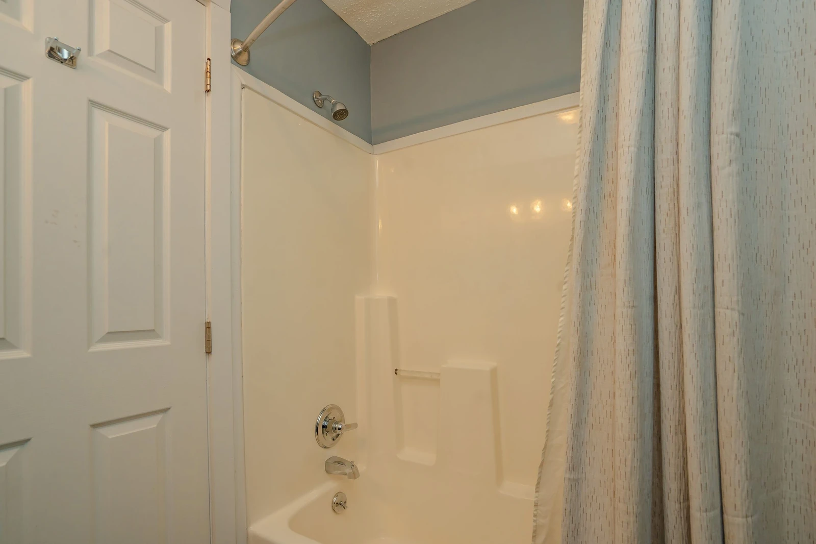 Your private bathroom features a spotless tub-shower combo with soothing coastal tones, perfect for unwinding after a day of exploring the area.