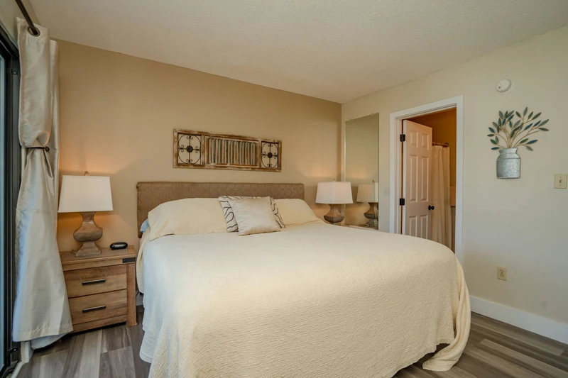 Slip into soft linens and drift off in this serene bedroom where warm lighting and coastal-inspired decor create your perfect retreat.
