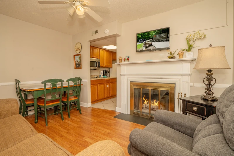 Unwind in your cozy living space where a crackling fireplace and comfortable seating invite you to relax after a day of exploring the Smokies.