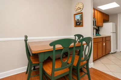 Your dining area is ready for home-cooked meals and morning coffee. The adjacent kitchen offers everything you need to prepare your favorite dishes in comfort.