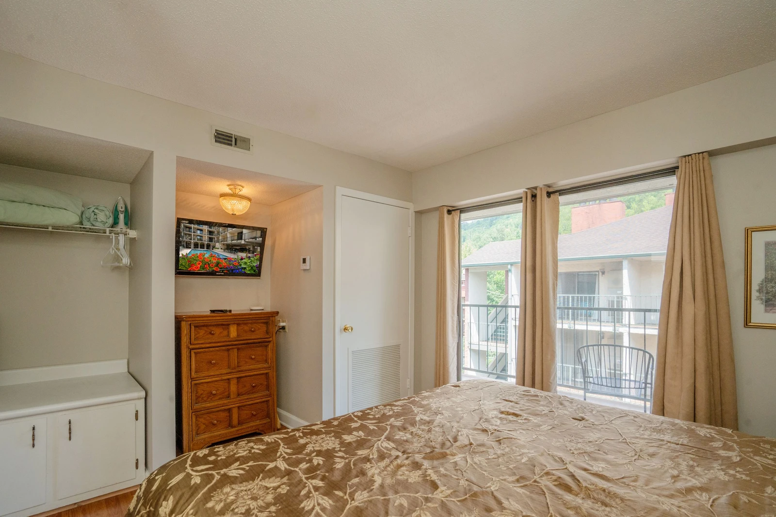 Wake up refreshed in this serene bedroom with natural light streaming through floor-to-ceiling windows. Step onto your private balcony and enjoy peaceful neighborhood views while you sip your morning coffee.