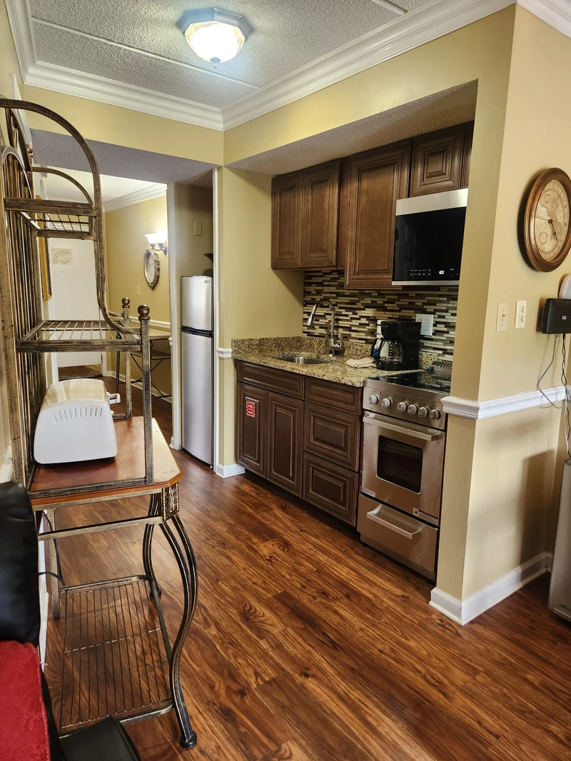 Step into your fully equipped kitchen with granite countertops, rich wood cabinetry, and stainless appliances. Everything you need to whip up a quick breakfast or a memorable dinner awaits—making your stay feel just like home.