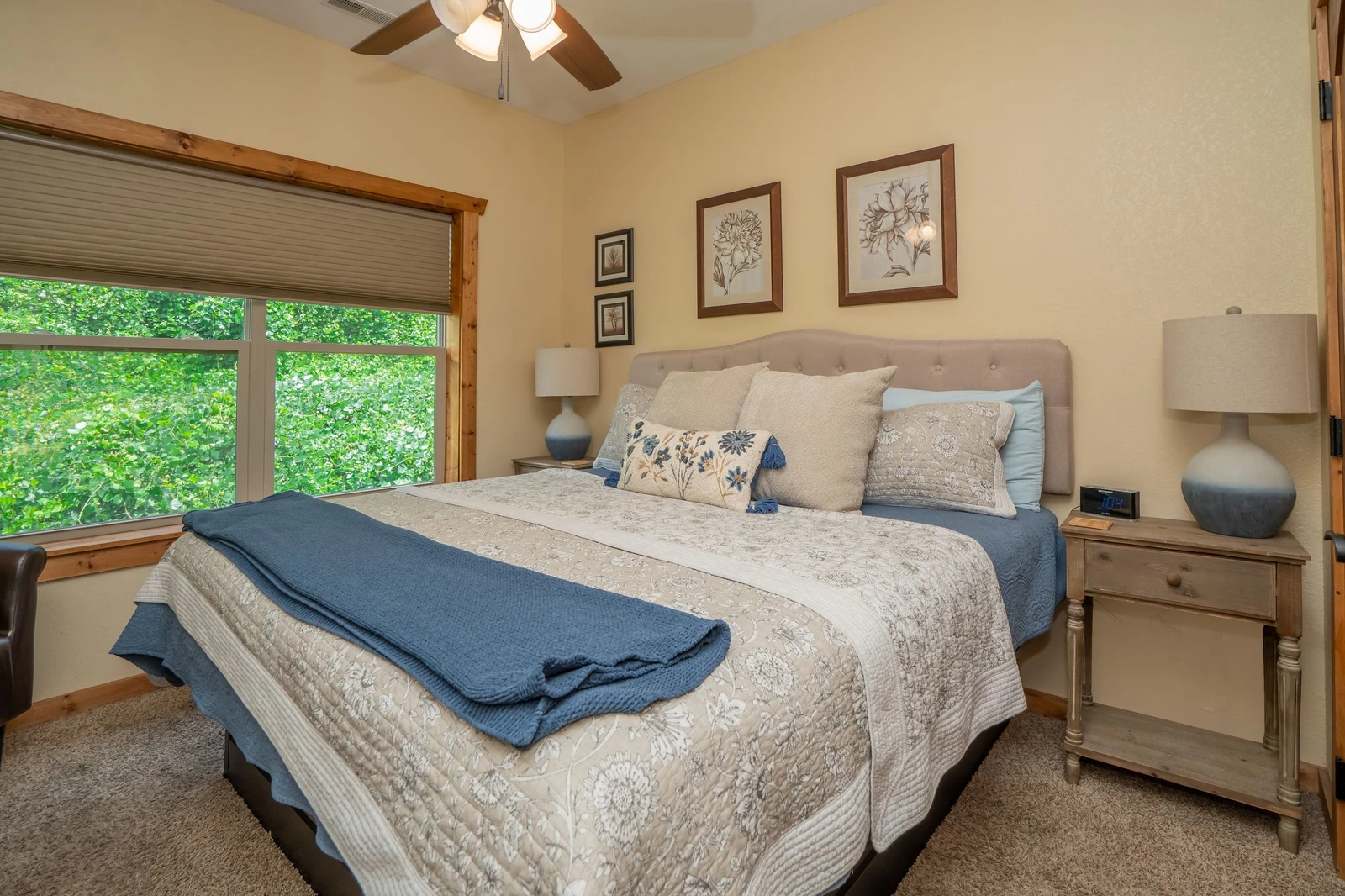 Unwind in your serene bedroom, where soft linens and a gentle ceiling fan invite restful nights. Natural light from the garden window fills the space with warmth.
