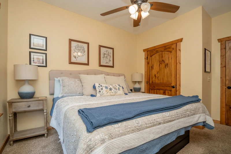 Sink into soft linens and unwind beneath the gentle ceiling fan in your cozy bedroom retreat.