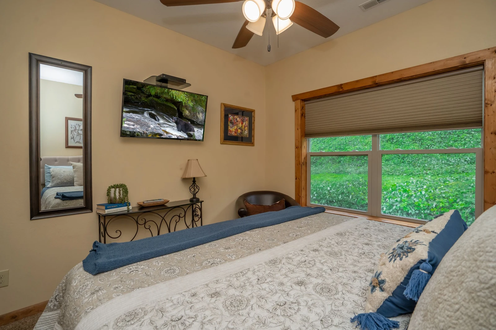 Your peaceful retreat features a plush bed and ceiling fan to keep you comfortable. Wake up to lush green views through the window and enjoy the serene, nature-filled surroundings.