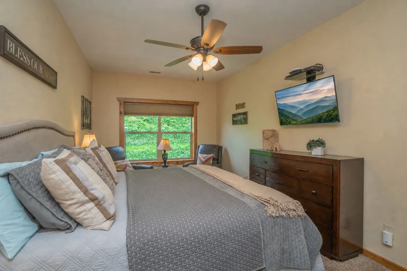 Sink into plush bedding and enjoy peaceful garden views from your serene bedroom retreat, where thoughtful details and comfortable furnishings create the perfect space to unwind after a day of adventure.