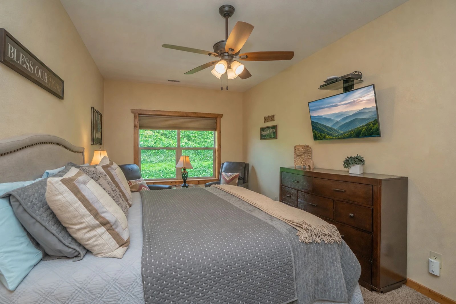 Sink into plush bedding and enjoy peaceful garden views from your serene bedroom retreat, where thoughtful details and comfortable furnishings create the perfect space to unwind after a day of adventure.