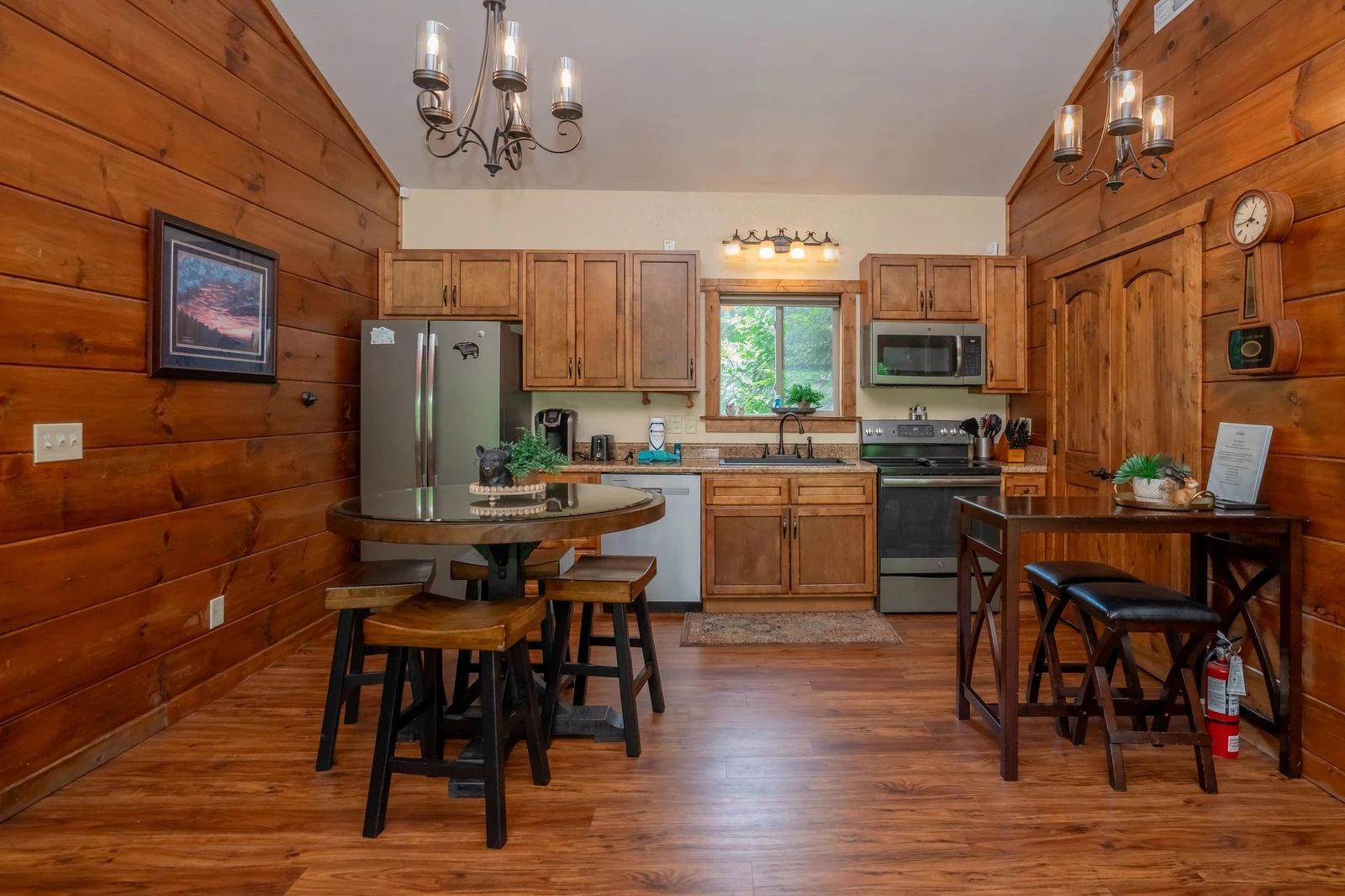 Step into your cozy cabin-style kitchen, where warm wood walls and natural light invite you to brew morning coffee and gather around the rustic table for meals with loved ones.