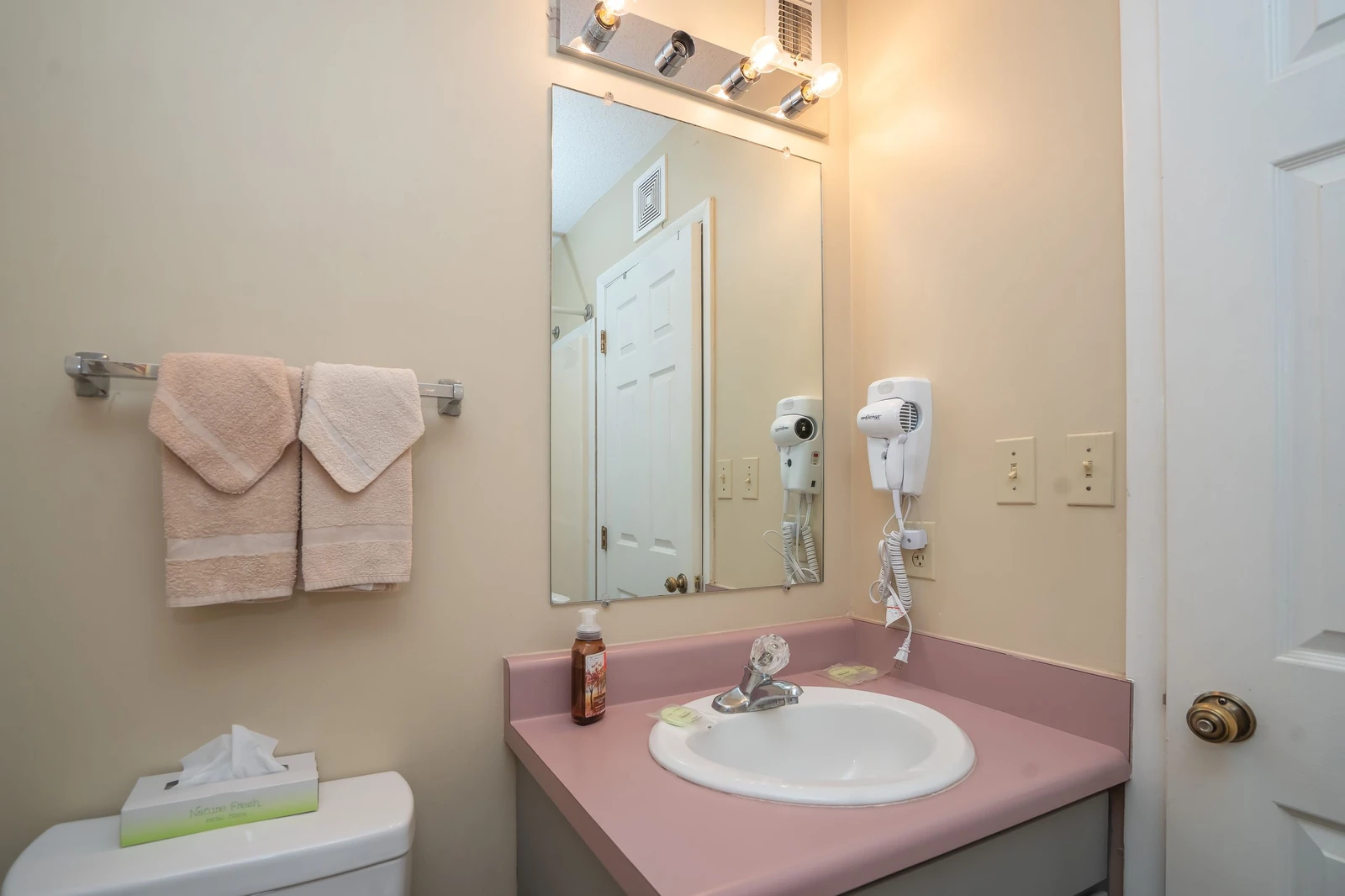 Freshen up at your private vanity area with plush towels, bright lighting, and convenient hair dryer at your fingertips.