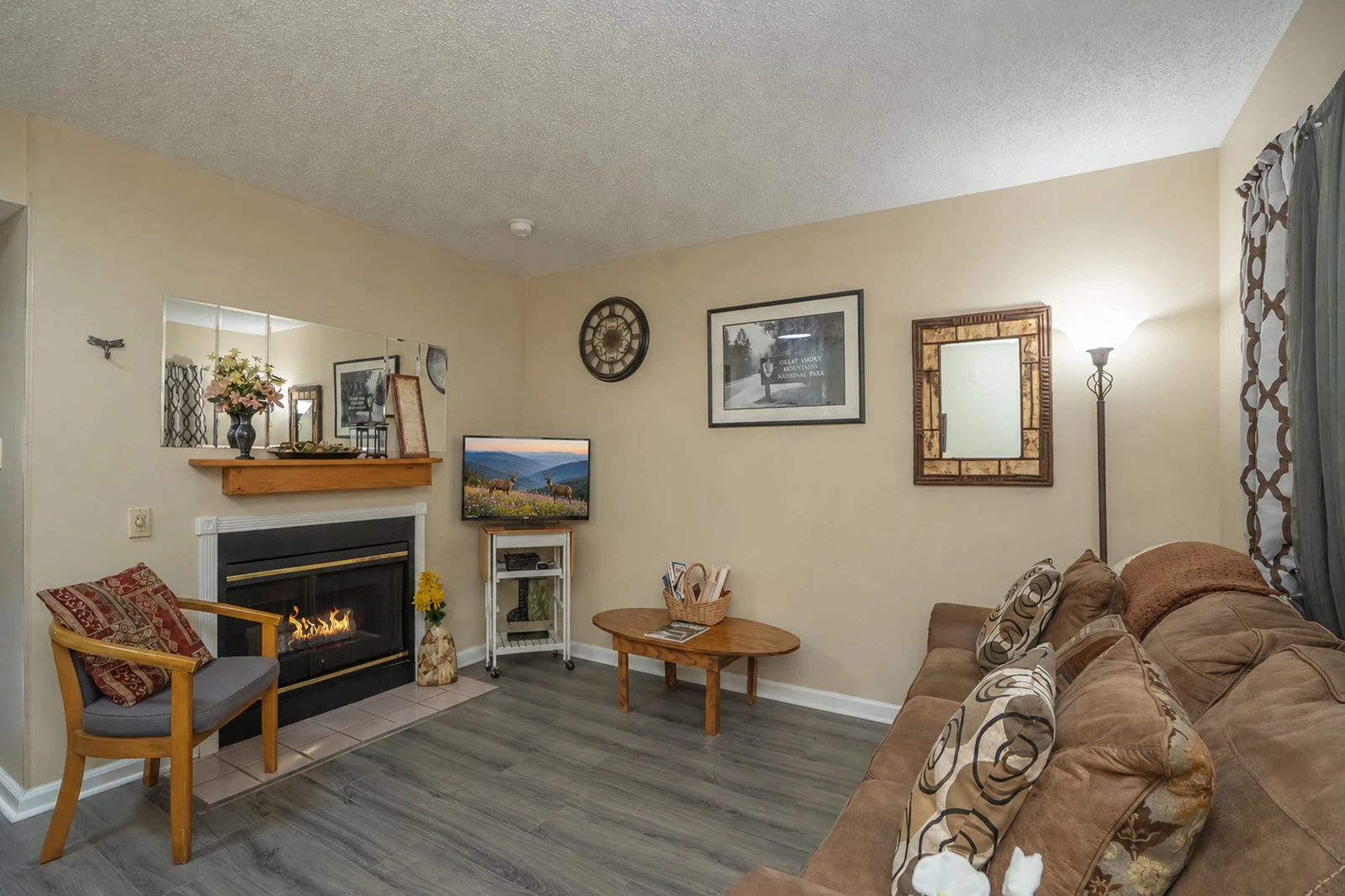 Settle into this welcoming living area where a cozy fireplace creates the perfect ambiance for your mountain getaway. Sink into the plush sofa with your favorite book or gather with loved ones for memorable evenings.