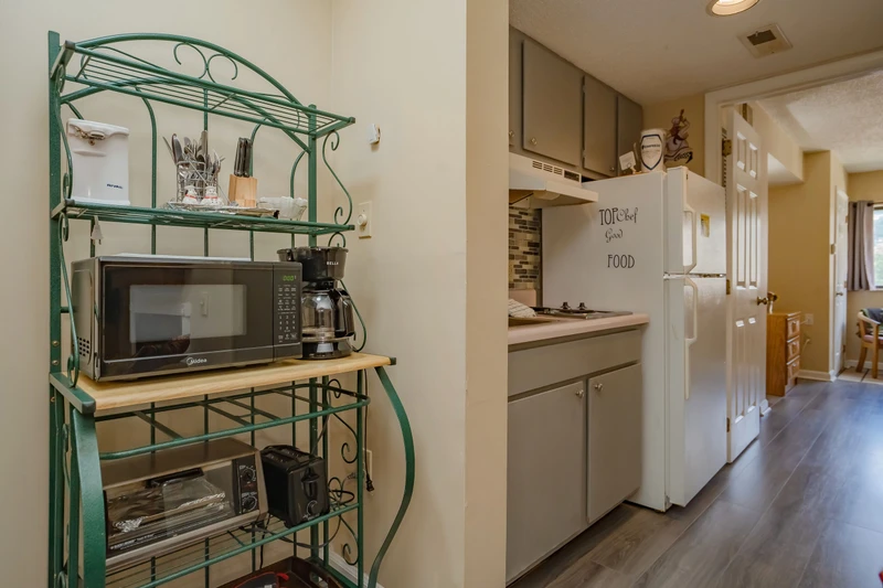 Step into your vacation kitchen, fully equipped for easy meal prep. A microwave, coffee maker, and all the essentials are at your fingertips, with charming touches that make it feel like home.