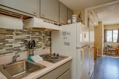 Your fully equipped kitchen has everything you need—sink, stove, and full-size refrigerator—ready for home-cooked meals during your stay.