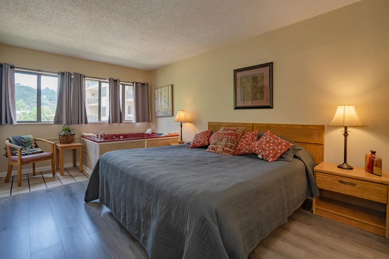 Wake up to soft light streaming through your windows and enjoy a restful retreat in this cozy bedroom. Warm wood tones and thoughtful touches create a welcoming space where you can truly unwind.