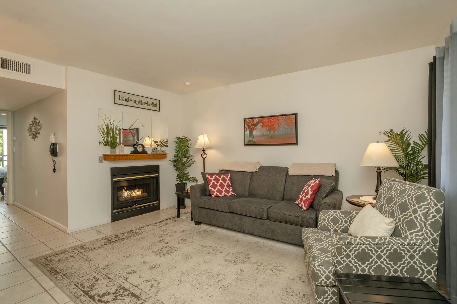 Unwind in your spacious living room, where a cozy fireplace and comfortable seating create the perfect retreat after exploring the area. Soft lighting and natural touches invite you to relax and feel right at home.
