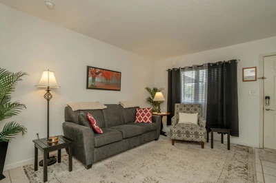 Settle into your private living space with soft furnishings and warm lighting. A perfect spot to unwind after exploring the area.