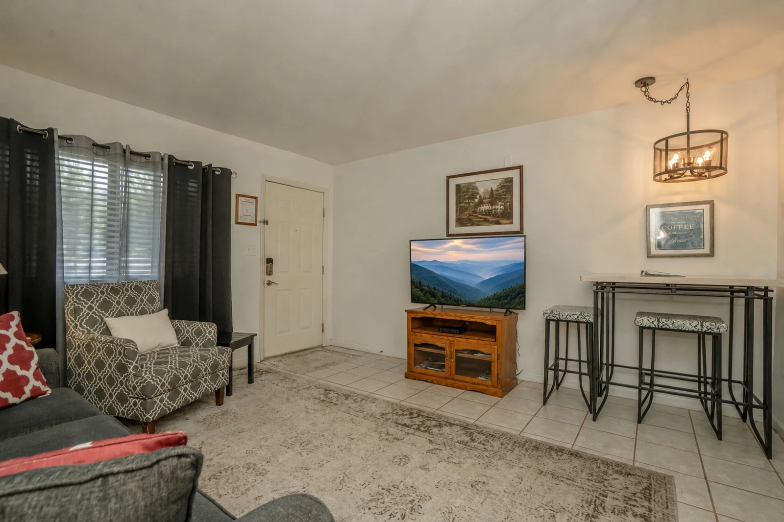 Step into your cozy retreat with tile floors, comfy seating, and warm lighting. The open layout blends the living area with a dining nook, creating a welcoming spot to unwind after exploring.
