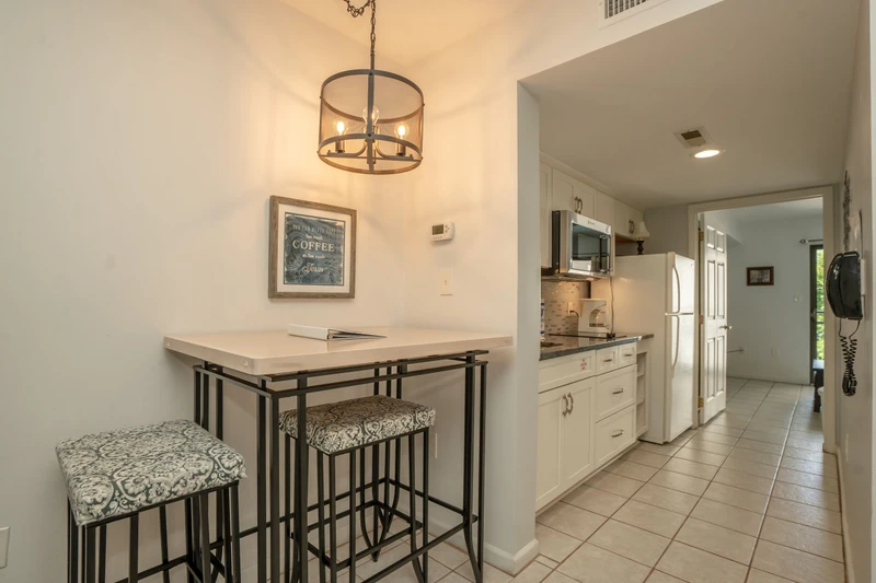 Bright, open-concept space perfect for your morning coffee and meal prep, with a cozy breakfast bar and a fully equipped kitchen just steps away.