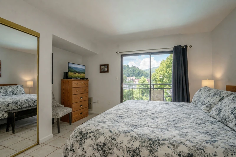 Your peaceful retreat features a plush queen bed dressed in soft linens and opens to a private balcony where mountain and lush greenery views await. Natural light floods the space, making it feel bright and airy.