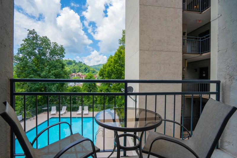 Step onto your private balcony and take in the refreshing pool views framed by lush greenery and rolling hills beyond. A perfect spot to sip morning coffee or unwind at day's end.