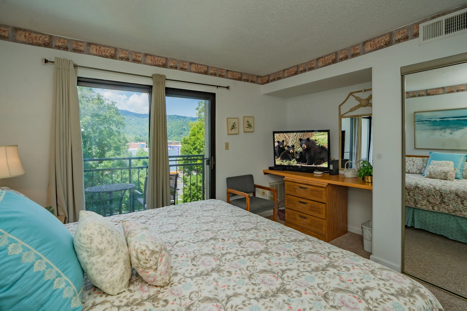 Sink into soft florals and wake up to mountain scenery framed by your private balcony—this cozy retreat blends vintage charm with peaceful views.