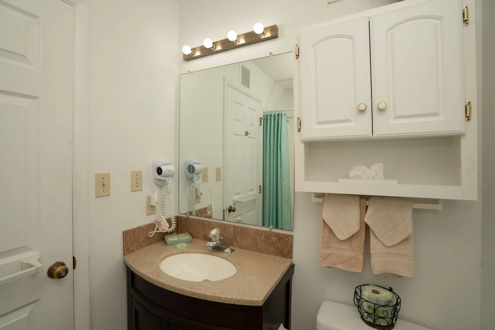 Your private bathroom features a gleaming vanity, bright lighting, and plush towels waiting for you. Fresh toiletries and thoughtful touches ensure a comfortable start to each day.