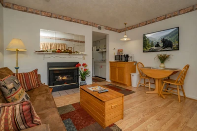 Curl up by the fireplace in this cozy living space, where warm wood tones and rustic touches create a welcoming retreat after your mountain adventures.