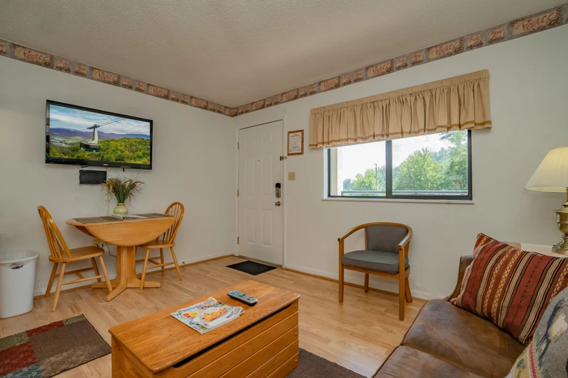 Step into your cozy retreat where warm wood tones and comfortable furnishings create the perfect home base for your mountain getaway. Natural light fills the space, inviting you to relax after a day of adventure.