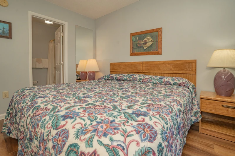 Step into your cozy bedroom where soft bedding and warm lighting set the tone for restful nights. The adjoining bathroom makes getting ready easy and comfortable.