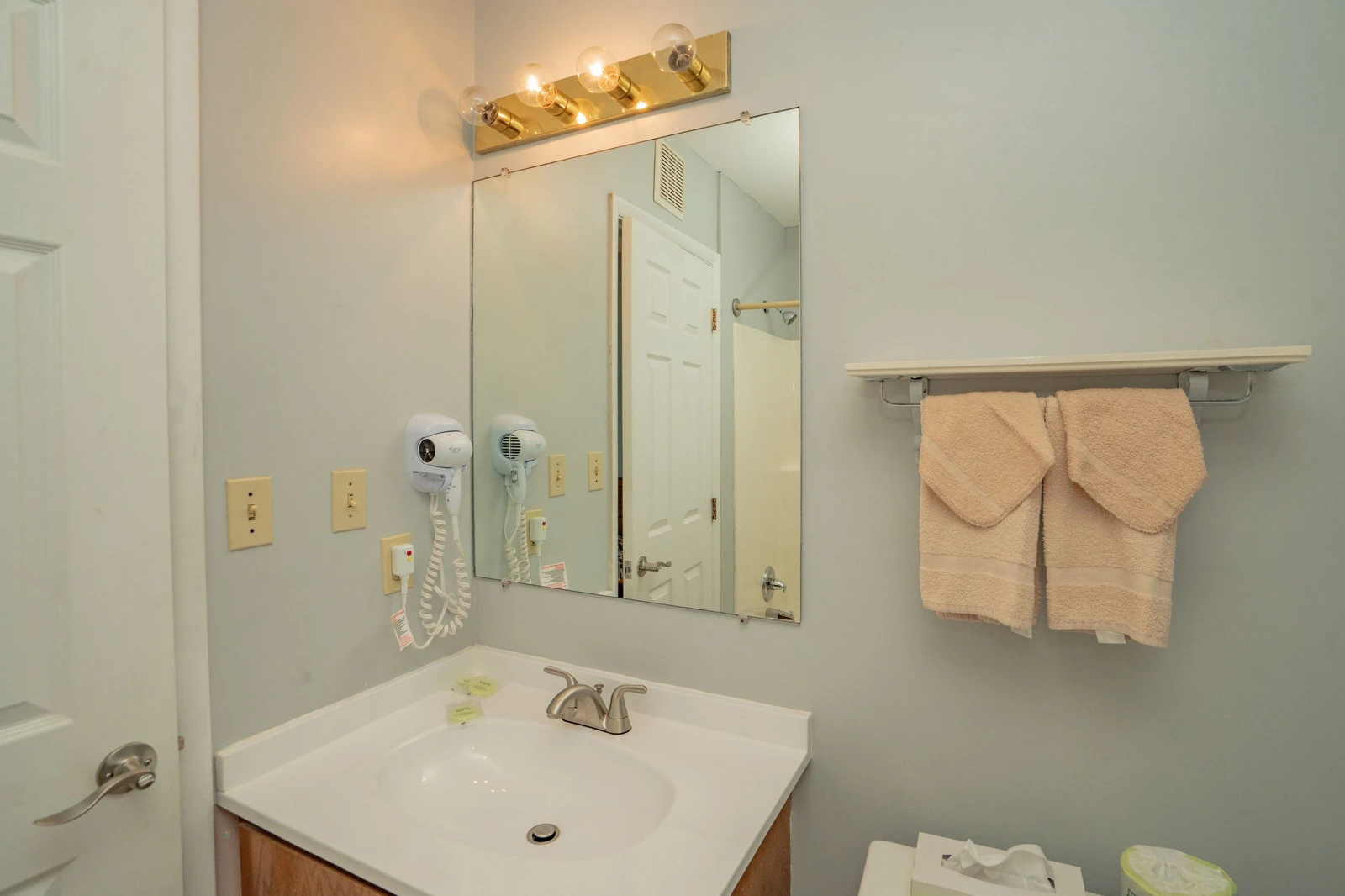 Step into your bright, clean bathroom—fresh towels and a hair dryer await to make getting ready effortless and comfortable.