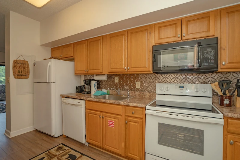 Your fully equipped kitchen makes meal prep effortless with ample counter space, modern appliances, and warm wood cabinetry—everything you need to whip up a quick breakfast or enjoy a relaxed home-cooked dinner during your stay.