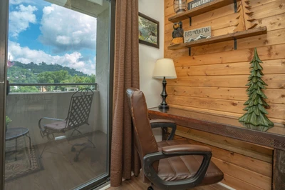 Settle into your cozy reading nook with rustic wood accents and step onto your private balcony to take in the surrounding mountain landscape and fresh air.