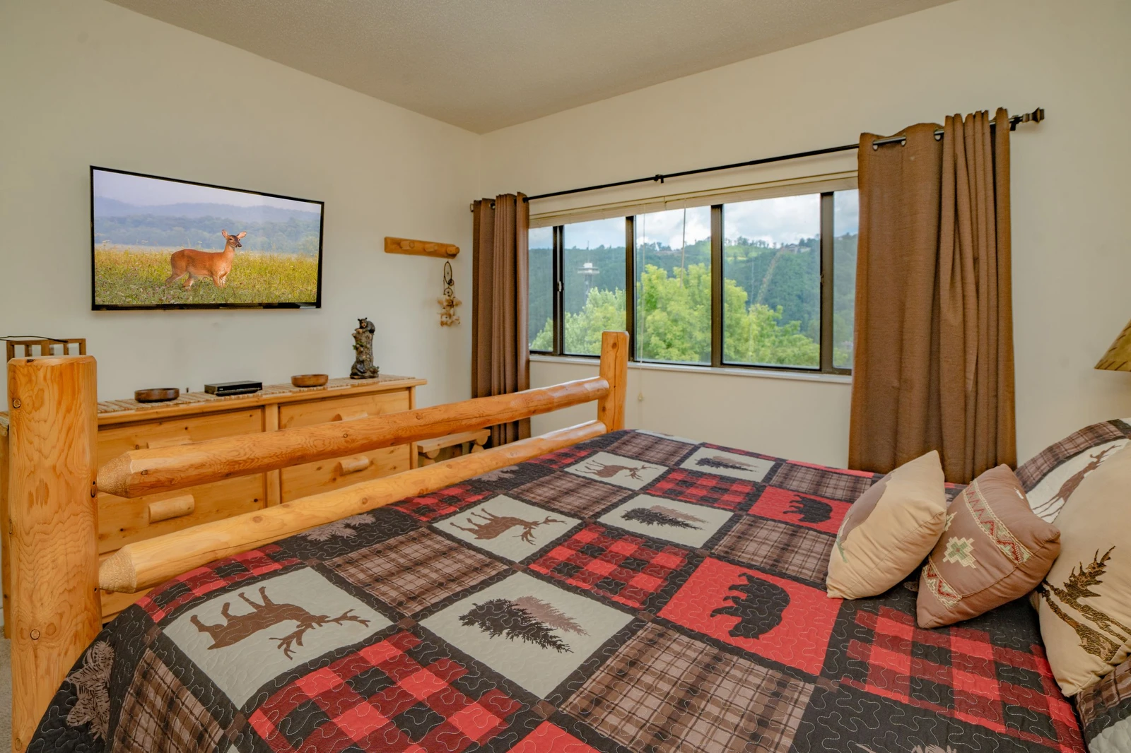 Wake up to stunning natural vistas from your cozy bedroom. The window frames peaceful greenery and rolling hills, letting you start each morning surrounded by nature's beauty.