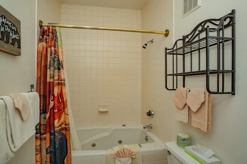 Freshen up in your private bathroom featuring a tub with jets for relaxation after a day of adventure. Fresh towels and essentials await your arrival.
