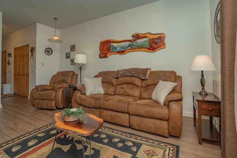 Settle into plush leather seating where natural light and rustic mountain charm create your perfect retreat for morning coffee or evening conversations.