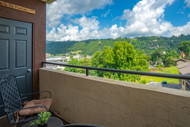 Step outside to your private balcony and take in sweeping views of lush hillsides, vibrant greenery, and the charming neighborhood below—your peaceful retreat awaits.