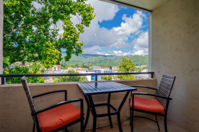 Step onto your private balcony and soak in stunning mountain views framed by lush greenery. Sip your morning coffee at the cozy bistro table as fresh air and peaceful scenery welcome your day.