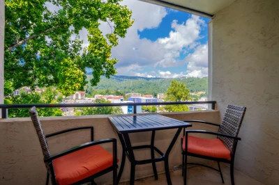 Step onto your private balcony and soak in stunning mountain views framed by lush greenery. Sip your morning coffee at the cozy bistro table as fresh air and peaceful scenery welcome your day.