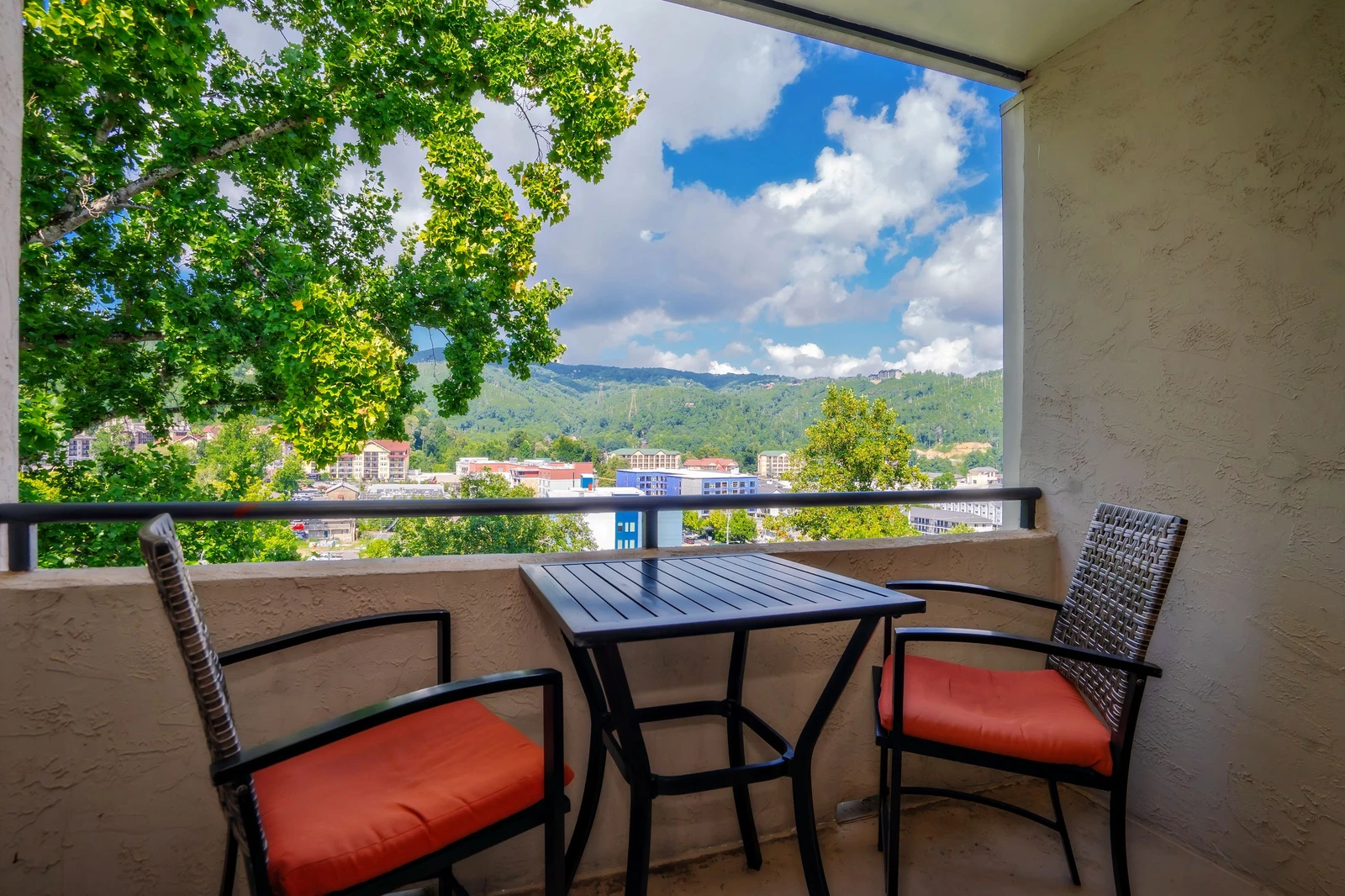Step onto your private balcony and soak in stunning mountain views framed by lush greenery. Sip your morning coffee at the cozy bistro table as fresh air and peaceful scenery welcome your day.