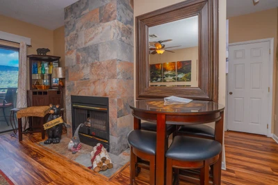Step into your inviting retreat where a cozy stone fireplace sets the scene for memorable evenings. The rich wood floors and warm tones create a welcoming atmosphere, perfect for relaxing after a day of mountain adventures.