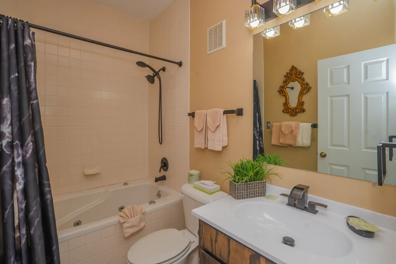 Your private bathroom features a full tub-shower combo, warm lighting, and thoughtful touches like soft towels and a touch of greenery to make you feel right at home.